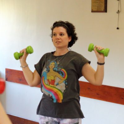 woman in exercise class lifting dumbell weights