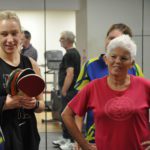 Woman in gym listening to instructor