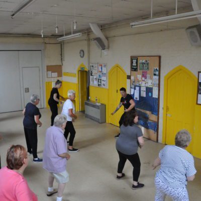 Group of people taking part in a Paracise exercise class