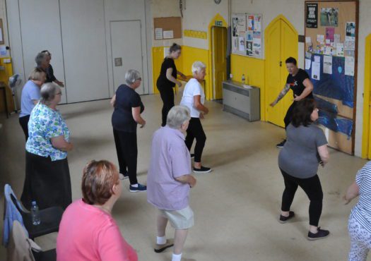 Group of people taking part in a Paracise exercise class