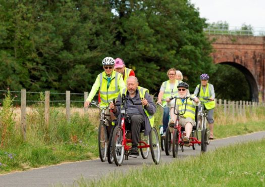 Group of cyclists riding adapted bicycles