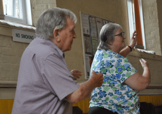 Male and female participating in an exercise class