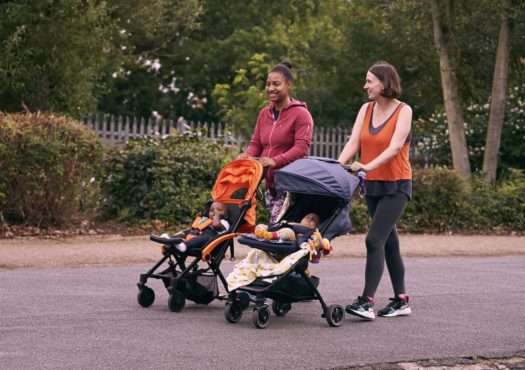 Two women walking with buggies