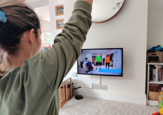 Woman doing an exercise class at home