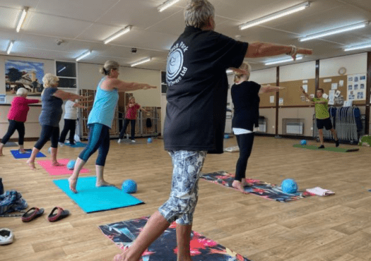 Group of ladies doing pilates exercises