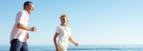 two people walking along beach