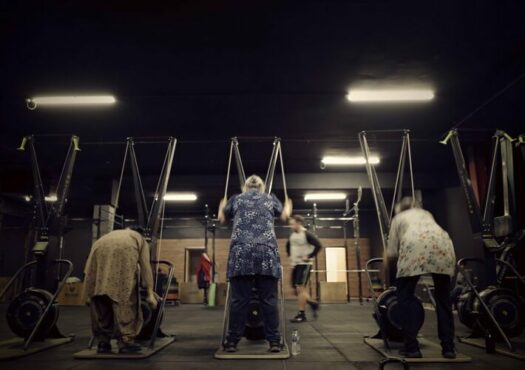 older people doing exercises in a gym