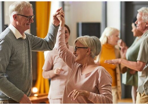 older people dancing in a hall