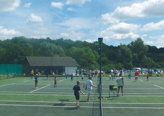 people playing tennis on tennis courts