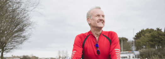 person smiling on a bike