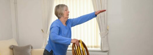 lady holding onto chair and stretching