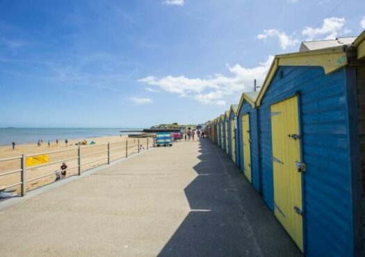 row of beach huts and promenade in St Mildred's Bay