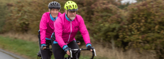 Two men cycling on a tandem bike