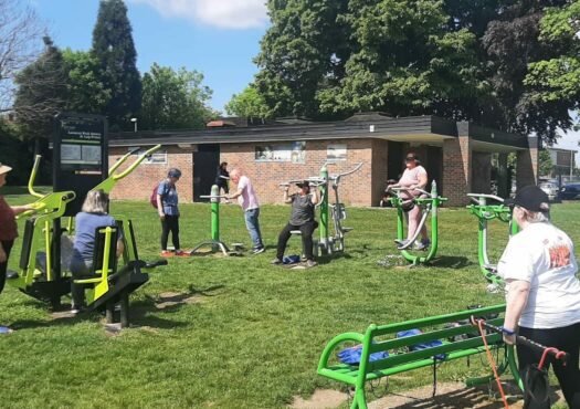 people on outdoor gym equipment in the park