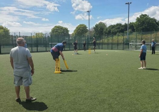 people playing walking cricket