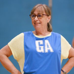 Christine smiling in a sports hall