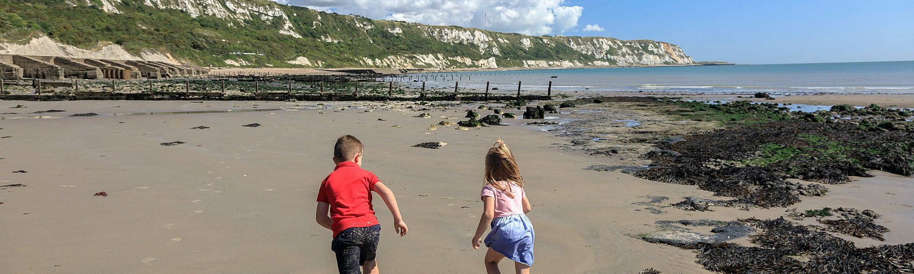 two children running on beach