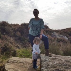 yasmin standing on a rock with her daughter